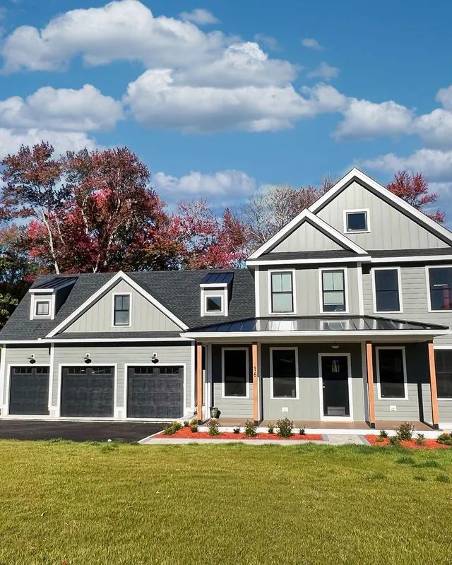 Gray farmhouse with standing seam accents over the porch