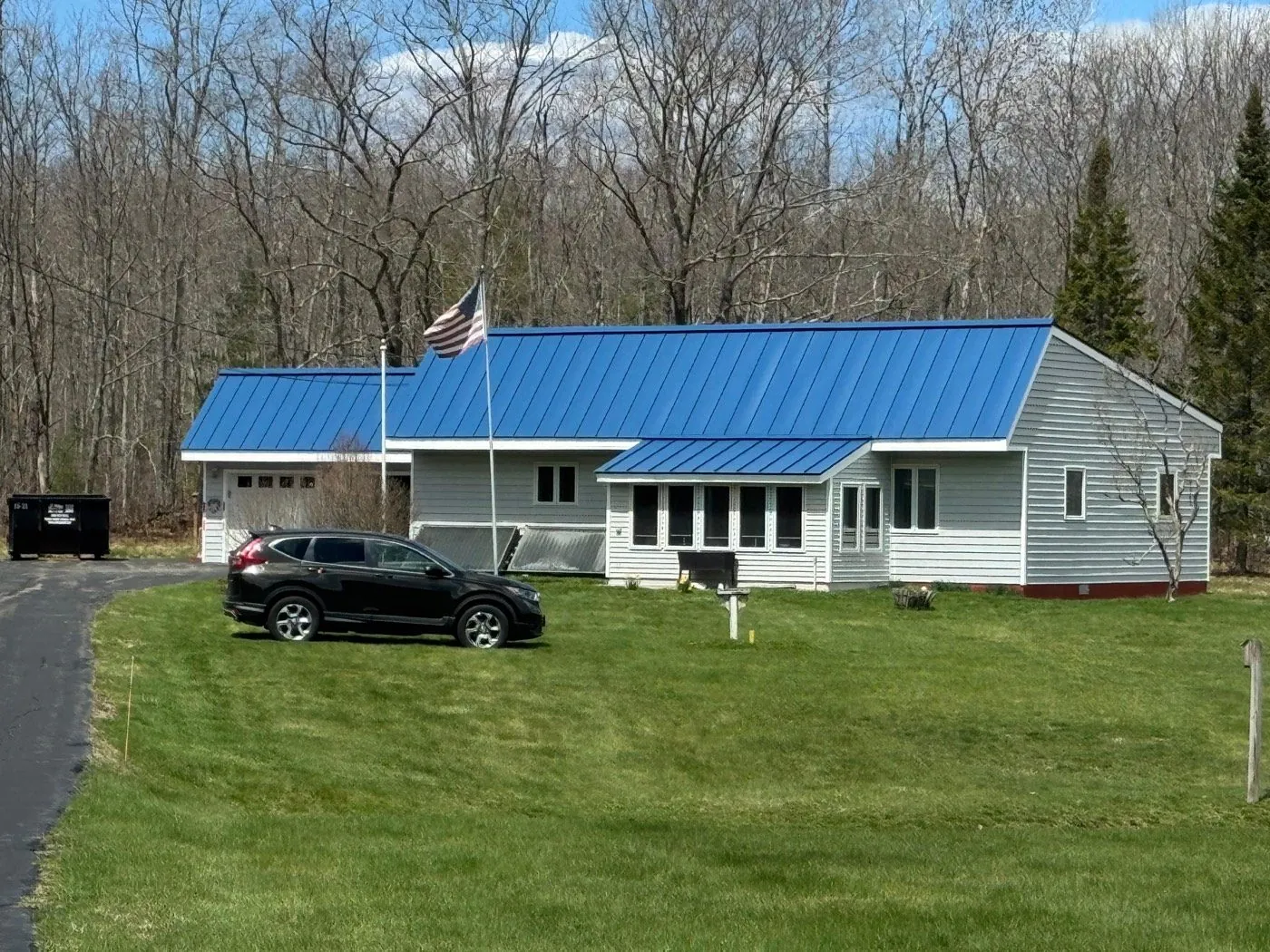 Ranch home and garage in blue standing seam